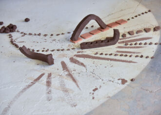 Clay arranged on the floor and markings.