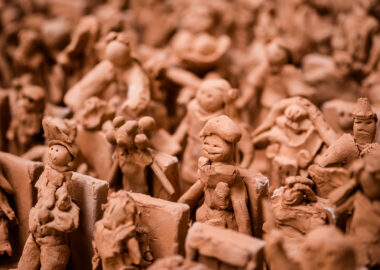 Terracotta clay figurines displayed in rows as part of the Cast of Thousands display at the 2019 Biennial.
