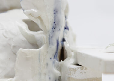 A close up shot of white glazed ceramic with flashes of blue.