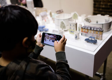 Young boy takes photo of Helen Beard's ceramic work at British Ceramics Biennial 2021