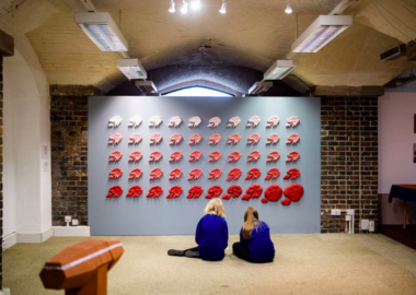 Two young students look at Ho Lai's ceramic work during the British Ceramics Biennial 2021