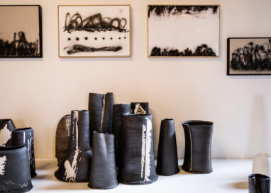 Cluster of black clay vessels as part of Dan Kelly's work in the 2023 British Ceramics Biennial