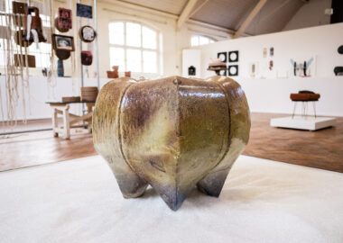 An apple-like clay stool as part of Leora Honeyman's work in the 2023 British Ceramics Biennial.