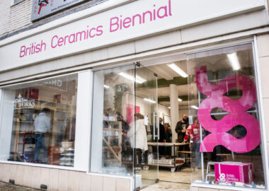 View from outside looking into the BCB Studio. People are gathered inside talking.