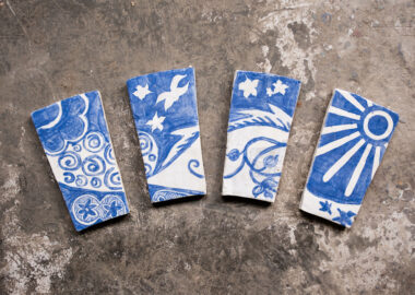 Blue and white ceramic tiles laid on a concrete floor.